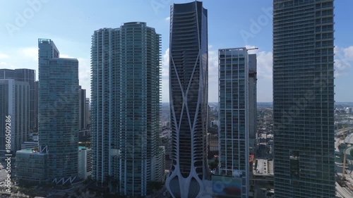Miami downtown with modern glass skyscrapers and dense high rise buildings filmed in daylight showing urban growth and business district