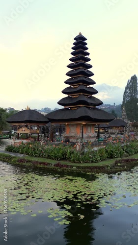 Aerial view of the iconic Ulun Danu Beratan Temple on the lake in Bali, Indonesia. Serene water and peaceful tropical surroundings.