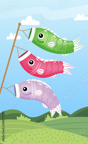 Three colorful Japanese koinobori carp streamers flying on a pole against a blue sky with green hills.