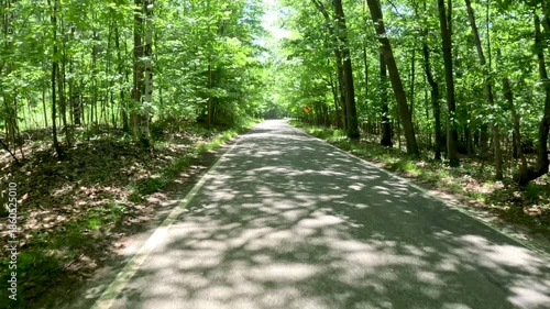 Tunnel of Trees Scenic M-119 Byway in Northern Michigan, USA. Reverse view. A 20-mile stretch of narrow, winding highway (also known as the M-119 Heritage Route) along the Lake Michigan shoreline.