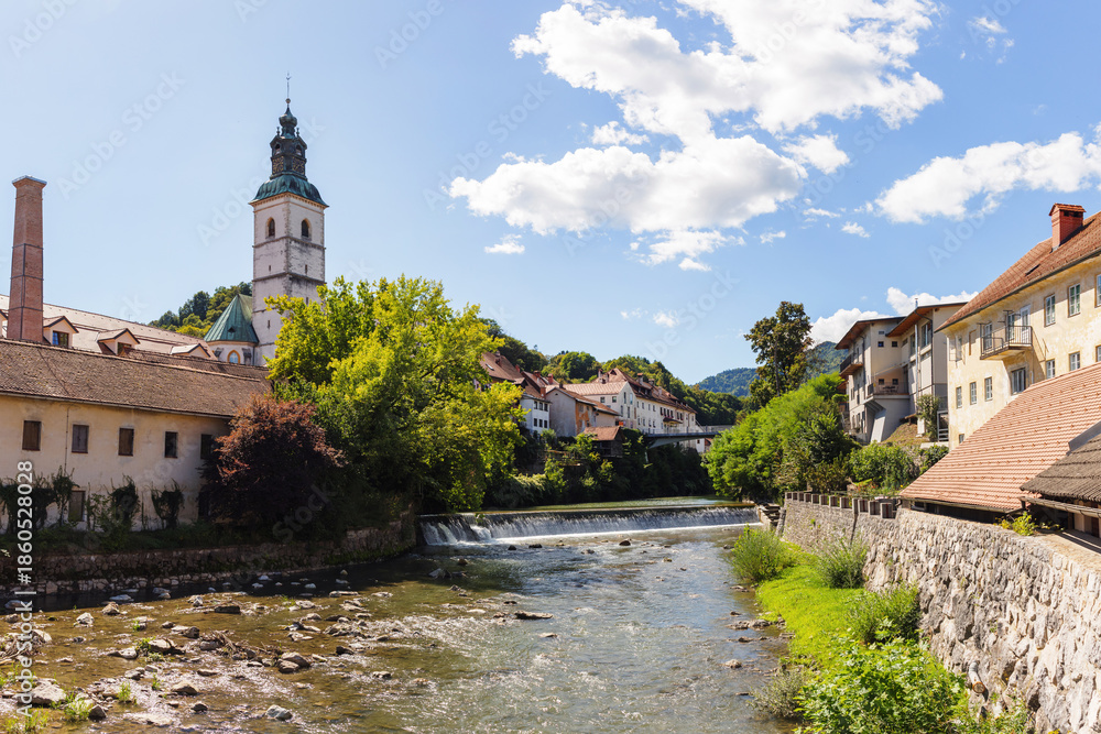 Fototapeta premium Explore Skofja Loka with its charming old town and historic architecture near a flowing river Sora and picturesque surroundings.