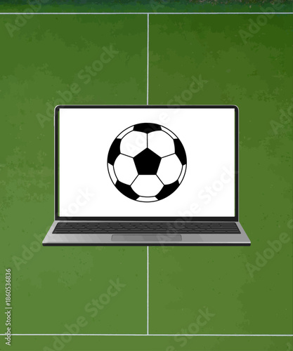 Modern laptop displaying a classic black and white soccer ball graphic centered perfectly above the bright green artificial turf of a marked sports field.