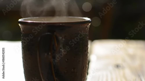 A steaming hot mug on a wooden table