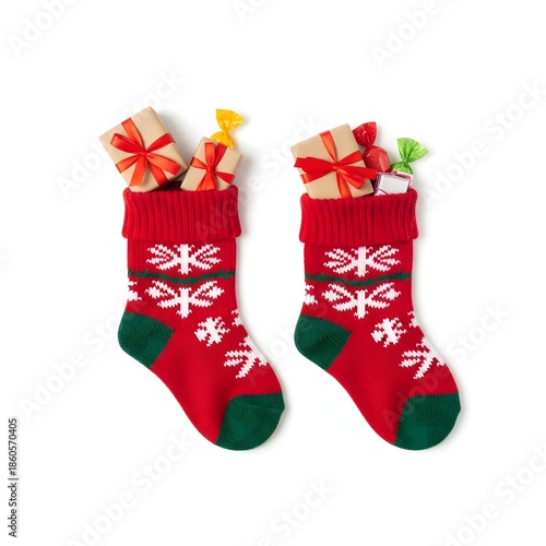 Two christmas stockings filled with gifts and candies arranged on white background studio shot