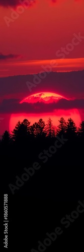 A vibrant red and orange fiery sunset behind the stark, dark silhouette of a forest,  dramatic,  landscape