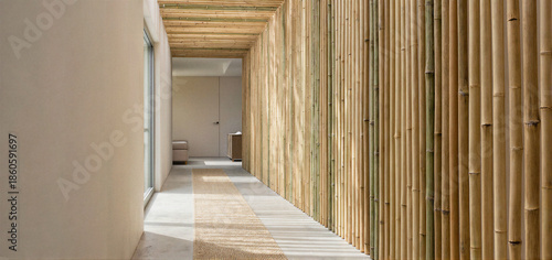 A modern hallway with a bamboo wall and concrete floor, featuring natural light from a window on the left.