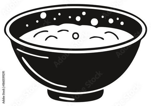 Bowl of thick, white, frothy soup with bubbles and swirls