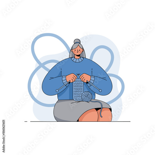 Elderly caucasian female knitting with blue yarn and sweater