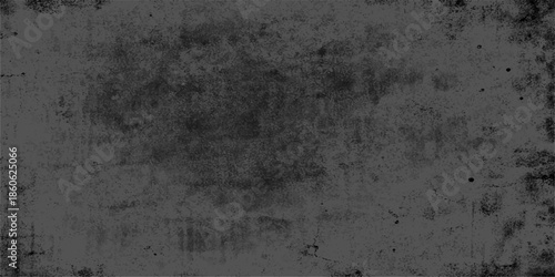 A dark aged concrete wall texture provides an abstract old grunge background with a blank grey stone surface pattern and copy space for a vintage backdrop design