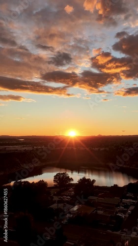 time lapseAerial footage of a lake surrounded by homes and lush green trees at sunset in Duarte California USA