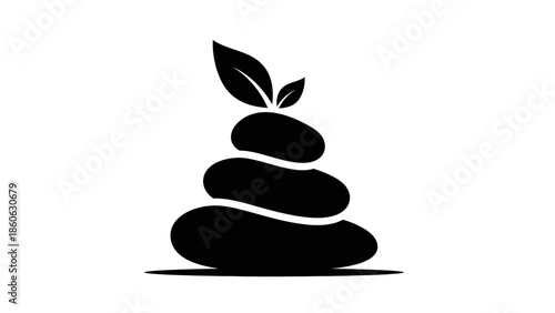 Black stacked stones with green leaf.