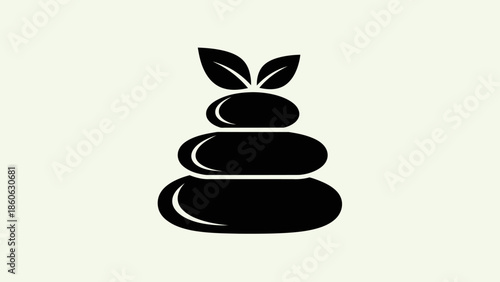 Black stacked stones with green leaves.