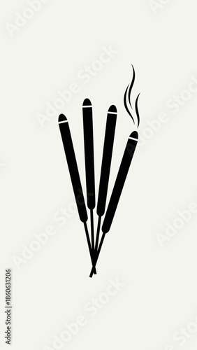 Incense sticks with smoke rising.