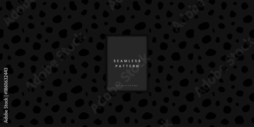 Minimalist seamless animal pattern featuring dark grey hyena or dalmatian spots or irregular dots on black background for modern apparel textile and abstract digital backdrop