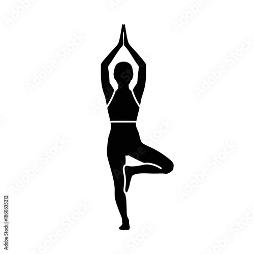 Woman in yoga tree pose standing.