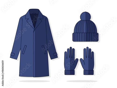 A dark blue trench coat knit pompom hat and pair of gloves on a white background