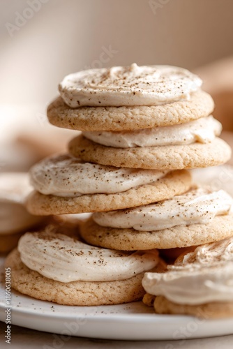 Stack of frosting cookies topped with cinnamon spice powder representing delicious sweet bakery dessert