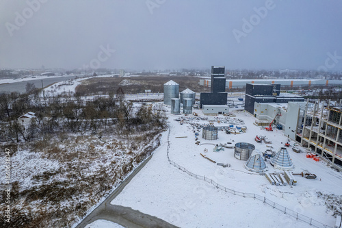 New building of pea protein factory construction site in Jelgava, Latvia. Aerial view, winter landscape with industrial buildings