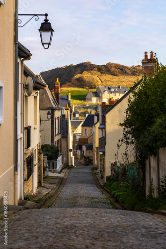 Fishing village on the edge of the English Channel in Port-en-Bessin seen from an alley