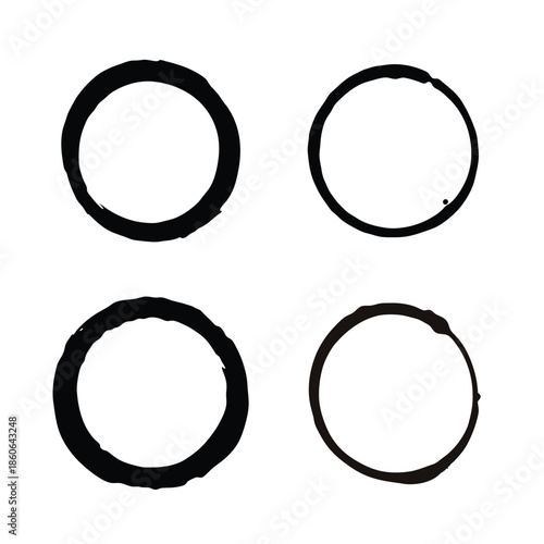 Abstract grunge black ink rings isolated on a clean white background, creating minimalist circular patterns