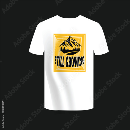 A white t-shirt featuring a graphic design of mountains with the text 'STILL GROWING' printed on it.