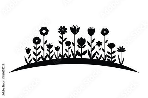 Black silhouette of garden flowers in a spring meadow