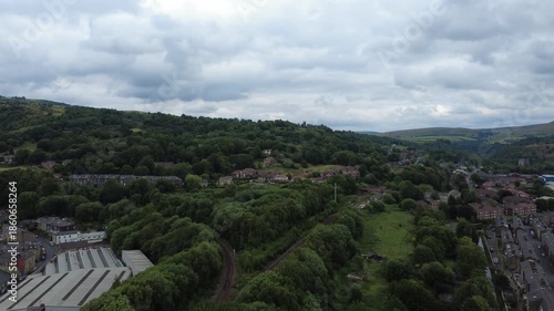 aerial drone view of the town of todmorden showing the market and streets with the railway line in the centre
