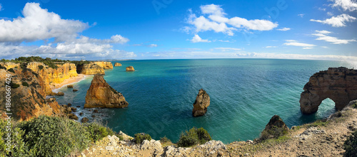 Natural arches underneath rugged cliffs, Praia da Marinha, Algarve, Portugal, Europe
