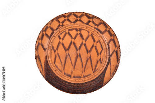 Handcrafted vintage carved and painted round decorative wooden plate isolated on the white background. Top view.