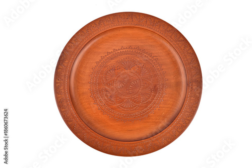 Handcrafted vintage carved round decorative wooden plate isolated on the white background. Top view.
