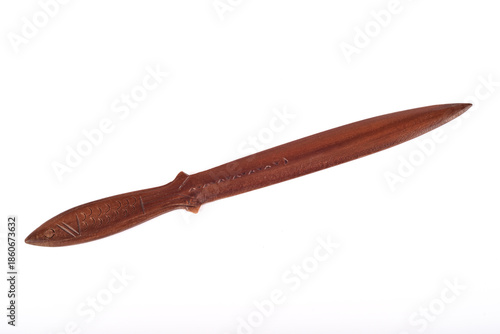 Handcrafted vintage carved decorative wooden knife isolated on the white background. Fish-shaped knife handle. Top view.