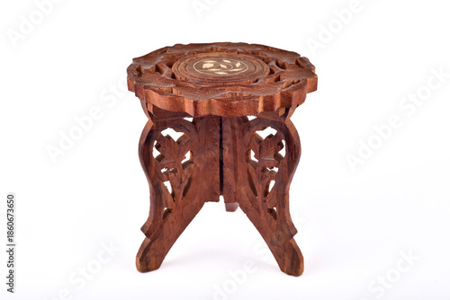Handcrafted vintage carved wooden stand or pedestal isolated on the white background. Selective focus.