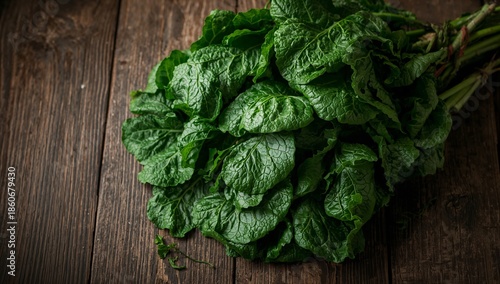 Fresh Green Leaves Arranged on a Wooden Surface in a Kitchen Setting During D...