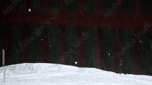 Slow-motion footage of a massive hail storm with large ice pellets violently striking the ground, capturing extreme weather intensity, icy textures, and atmospheric chaos under dark, stormy skies.