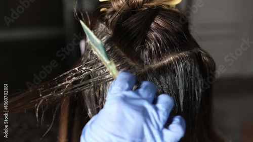 Brightening up hair color with a new dye while carefully applying the product in a relaxed environment. Focusing on roots and sections for an even finish.