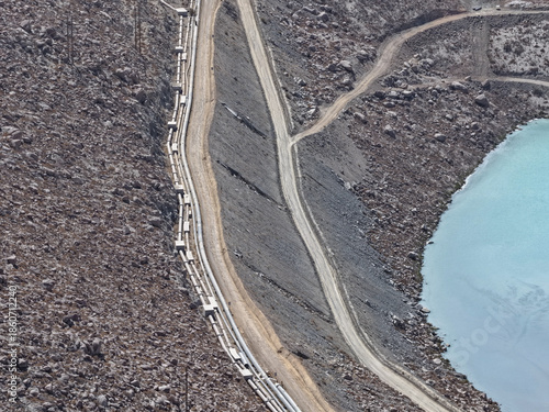 Aerial view of water and mining tailings pipelines to tailings dams