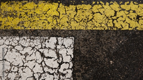 white and yellow paint line on asphalt