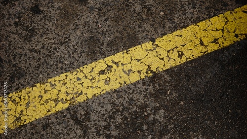 yellow paint on asphalt