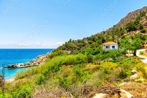 Trapalou trapalo beach, Ikaria Greek island Greece with high angle aerial view on shore coast, coastal buildings houses by Icarian sea