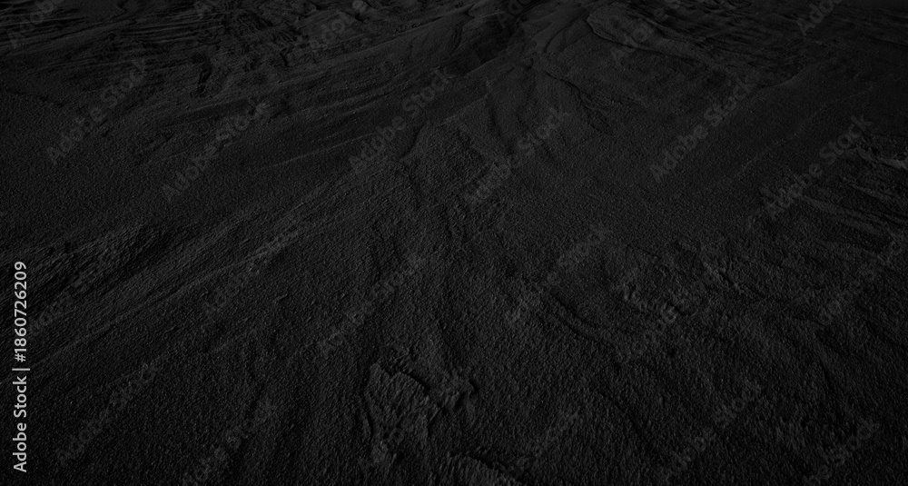 Fototapeta premium Black and White Sand beach macro photography. Texture of black and whote sand for background. Close-up macro view of volcanic sand surface black and white color. Black texture sand in the desert.