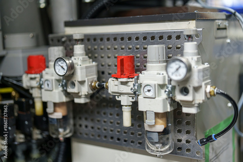 Machinery setup with pressure regulators and filters in an industrial environment near a manufacturing plant
