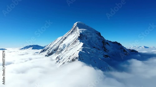 Wallpaper Mural Snow covered mountain peak rising above the clouds on a sunny day Torontodigital.ca