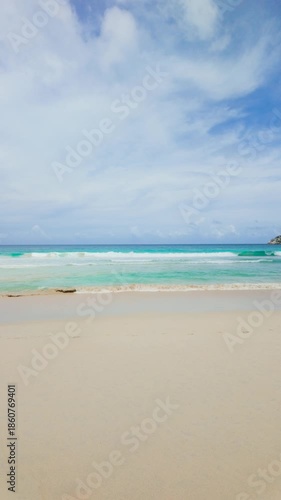 Wallpaper Mural Turquoise ocean waves under clear skies with serene and calm atmosphere on a sandy beach. Seychelles, Mahe. Torontodigital.ca