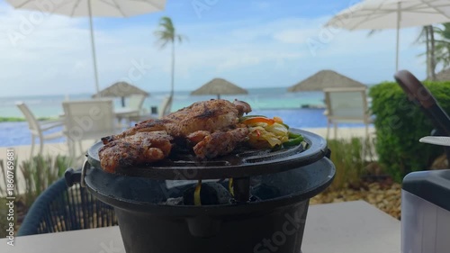 BBQ Roasted Chicken on The Hot Charcoal Grill Close-up. Tasty Snack For Outdoor BBQ in vacations.