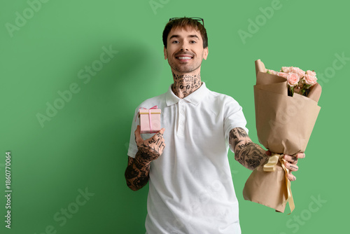 Happy young man with bouque...