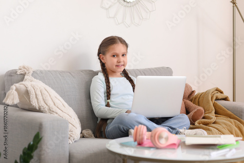 Little girl with laptop stu...