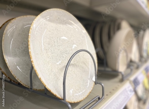 Many plates on the shelf in the store	
