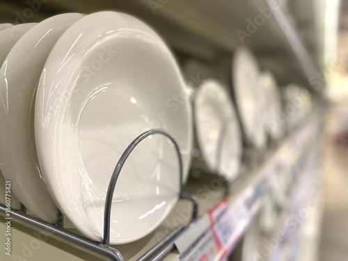 Many plates on the shelf in the store	
