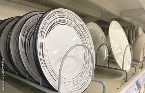 Many plates on the shelf in the store	
