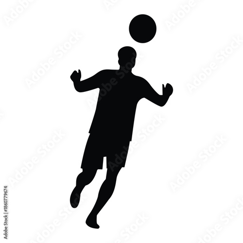 Silhouette of a man playing soccer with ball